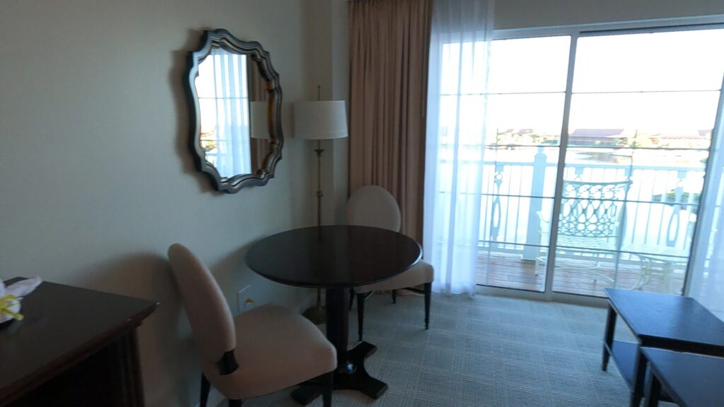 Table and chairs with electrical outlets on wall beneath the table